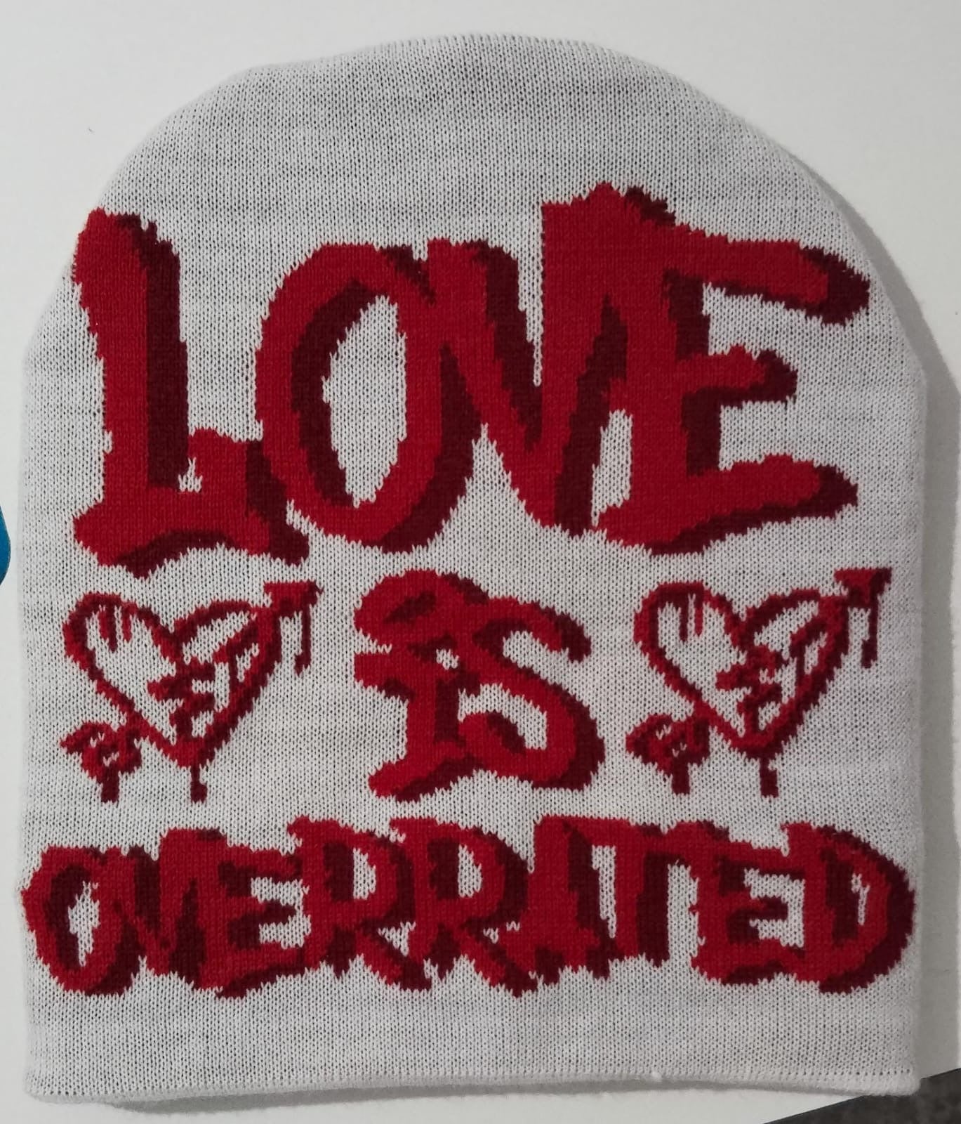 White and red Love is overrated beanies with red satin inside