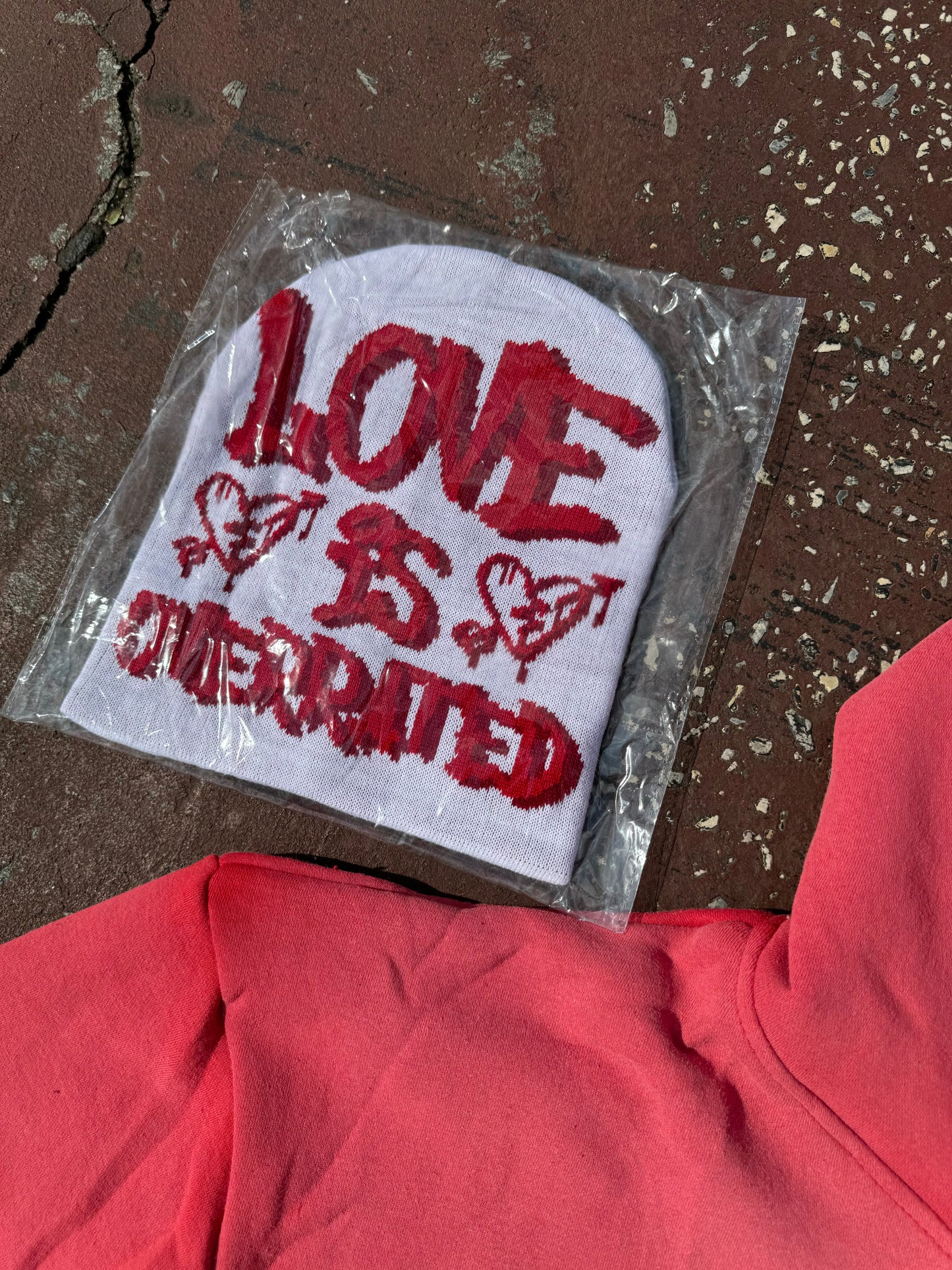 White and red Love is overrated beanies with red satin inside